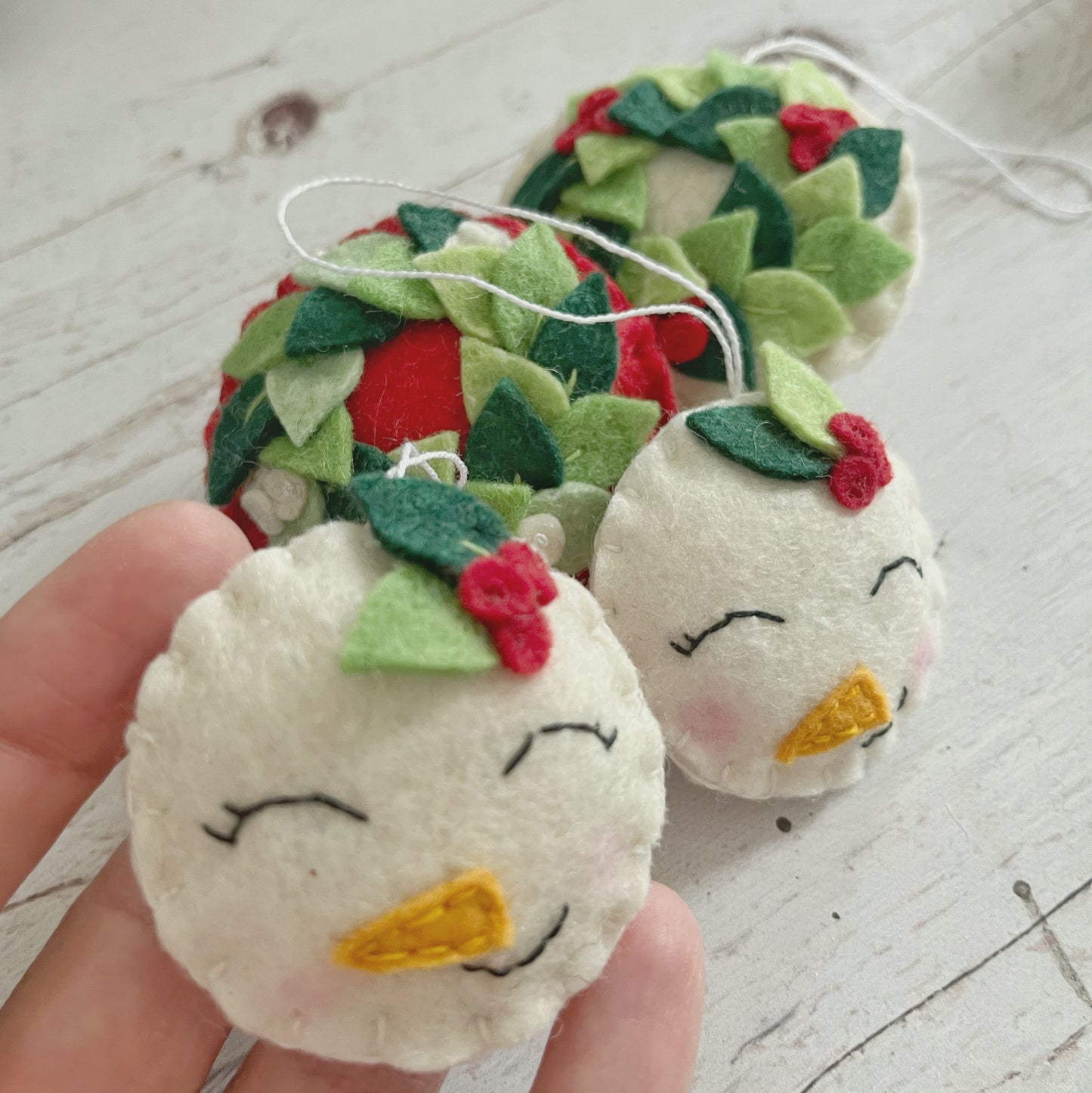 Felt snowman ornament with leaves, smiling snowman