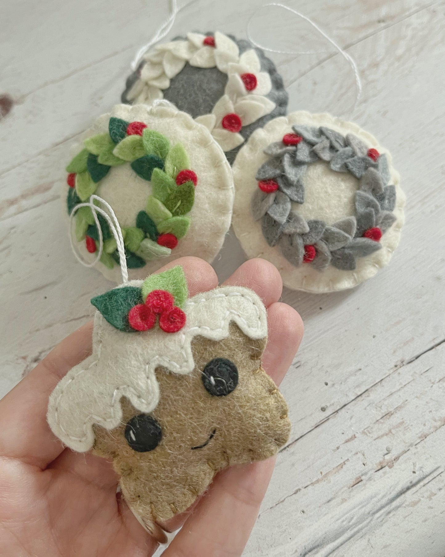 Gingerbread cookie ornament with leaves, smiling star heart and round face